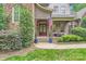 Inviting front porch with double doors, comfortable seating, American flag, and manicured landscaping at 1056 James Madison Dr, Matthews, NC 28104
