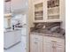Butler's pantry features marble countertops, custom cabinets and a beverage center at 1056 James Madison Dr, Matthews, NC 28104