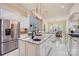 Open concept kitchen with an oversized island, marble countertops, and stainless steel appliances at 1056 James Madison Dr, Matthews, NC 28104