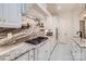 Close up of white cabinets, marble backsplash and countertops in a gourmet kitchen at 1056 James Madison Dr, Matthews, NC 28104