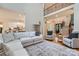 Open-concept living room with hardwood floors, plush seating, and a view of the kitchen and grand staircase at 1056 James Madison Dr, Matthews, NC 28104