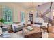 Bright living room showcasing a staircase, hardwood floors, neutral decor, and ample natural light at 1056 James Madison Dr, Matthews, NC 28104