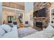 Bright living room with a stone fireplace, soaring ceilings, and access to the upper-level hallway at 1056 James Madison Dr, Matthews, NC 28104