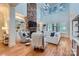 Spacious living room with high ceilings, stone fireplace, built-in shelves, and large windows providing ample light at 1056 James Madison Dr, Matthews, NC 28104