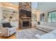 Inviting living room with a floor-to-ceiling stone fireplace, built-in bookshelves, and comfortable seating at 1056 James Madison Dr, Matthews, NC 28104