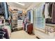 Walk-in closet with custom shelving, clothing racks, and natural light at 1056 James Madison Dr, Matthews, NC 28104