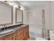 Bathroom featuring a double sink vanity with detailed wood, framed mirrors, tub and shower combination at 111 E Church St, Stanley, NC 28164
