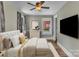 Cozy bedroom featuring plush bedding, a ceiling fan, and a large window for natural light at 111 E Church St, Stanley, NC 28164
