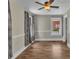 Bright bedroom featuring wood floors, a ceiling fan, and natural light streaming through the window at 111 E Church St, Stanley, NC 28164