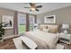 Comfortable bedroom with a large window, decorative pillows, and hardwood flooring for a cozy retreat at 111 E Church St, Stanley, NC 28164