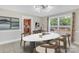 Stylish dining room featuring modern lighting, large windows, tile floors, and an open view to kitchen at 111 E Church St, Stanley, NC 28164