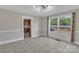 Spacious dining room with tile floors, large window, and an open view to the kitchen at 111 E Church St, Stanley, NC 28164