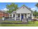 Charming white home featuring a cozy front porch with black railings and a bright blue front door at 111 E Church St, Stanley, NC 28164