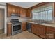 Well-equipped kitchen with stainless steel appliances and wooden cabinetry at 111 E Church St, Stanley, NC 28164