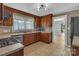 Functional kitchen featuring wooden cabinets, a stainless steel sink, and modern appliances at 111 E Church St, Stanley, NC 28164