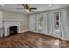 Inviting living room featuring hardwood flooring, a fireplace, and plenty of natural light at 111 E Church St, Stanley, NC 28164