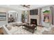 Cozy living room featuring a decorative fireplace, large windows, and open layout into the dining area at 111 E Church St, Stanley, NC 28164