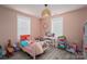 Pink bedroom with lots of natural light and a white bed, desk and shelving and plank flooring at 1138 Zeb Haynes Rd, Maiden, NC 28650