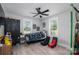 Bedroom with a black metal bed, gray walls and plank flooring and a black ceiling fan and window views at 1138 Zeb Haynes Rd, Maiden, NC 28650