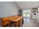 Bright dining area features rustic wooden table and bench seating, with french doors to the backyard at 1138 Zeb Haynes Rd, Maiden, NC 28650