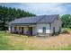Well-maintained home with a metal roof, white siding, and a covered porch perfect for outdoor relaxing at 1138 Zeb Haynes Rd, Maiden, NC 28650