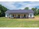 Charming single-story home with a covered front porch featuring a hammock and rocking chairs, surrounded by a lush green lawn at 1138 Zeb Haynes Rd, Maiden, NC 28650