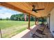 Relaxing front porch with comfortable seating, ceiling fans, and a serene view of the surrounding landscape at 1138 Zeb Haynes Rd, Maiden, NC 28650