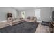 Cozy living room with plush sofas, a large area rug, and ample natural light from the backyard at 1138 Zeb Haynes Rd, Maiden, NC 28650