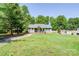 A cozy one-story home with a well-manicured lawn, a shed, and surrounded by lush trees at 1170 Scenic Dr, Shelby, NC 28150