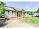 Inviting single-story home with a covered front porch, rocking chairs, and a concrete driveway at 1170 Scenic Dr, Shelby, NC 28150