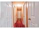 Well-lit hallway with wood floors showcases multiple doors and access to various rooms at 1170 Scenic Dr, Shelby, NC 28150