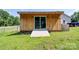 Backyard view of a wooden outbuilding with sliding glass doors and a concrete ramp at 1170 Scenic Dr, Shelby, NC 28150