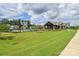Spacious community grounds showcasing lush green lawn and a clubhouse at 12531 Bryton Ridge Pkwy, Huntersville, NC 28078