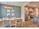 Open dining room adjacent to kitchen features a wood table and modern light fixture at 12531 Bryton Ridge Pkwy, Huntersville, NC 28078