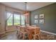 Bright dining room features a wood table, stylish lighting, and a large window with sheer curtains at 12531 Bryton Ridge Pkwy, Huntersville, NC 28078