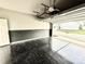 Spacious garage featuring epoxy flooring, two-toned walls and an automatic garage door at 12531 Bryton Ridge Pkwy, Huntersville, NC 28078