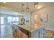 Granite island in modern kitchen with stainless appliances and open concept design at 12531 Bryton Ridge Pkwy, Huntersville, NC 28078