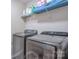 This laundry room offers modern washer and dryer units, with practical shelving for storage at 12531 Bryton Ridge Pkwy, Huntersville, NC 28078