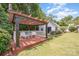 Inviting backyard deck featuring a pergola, comfortable seating, and manicured landscaping for outdoor enjoyment at 130 Greenwich Dr, Statesville, NC 28677