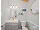 Bathroom with gray vanity, framed mirror, nautical decor, and a white toilet at 130 Greenwich Dr, Statesville, NC 28677
