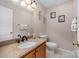 Powder room features granite countertop and vanity with decorative mirror and wall art at 130 Greenwich Dr, Statesville, NC 28677