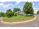 Charming home with a large yard, white picket fence and lush landscaping on a sunny day at 130 Greenwich Dr, Statesville, NC 28677