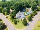 An aerial view reveals a landscaped front yard and a charming home with a relaxing front porch at 130 Greenwich Dr, Statesville, NC 28677