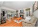 Cozy living room featuring a fireplace, hardwood floors, and comfortable furnishings at 130 Greenwich Dr, Statesville, NC 28677