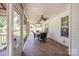 Covered patio with tiled floor, ceiling fans and outdoor dining set at 130 Greenwich Dr, Statesville, NC 28677