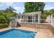 Inviting pool area with outdoor seating and covered patio, offering a perfect space for relaxation at 130 Greenwich Dr, Statesville, NC 28677