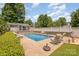 A beautifully landscaped backyard features a sparkling pool with plenty of space for lounging and entertaining at 130 Greenwich Dr, Statesville, NC 28677