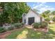 Charming backyard shed surrounded by lush greenery and beautiful roses, offering a serene garden space at 130 Greenwich Dr, Statesville, NC 28677
