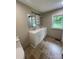 Updated bathroom featuring double sinks, vanity, and window at 1327 Wiscassett St, Albemarle, NC 28001