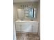 A modern bathroom featuring a double sink vanity, tile floors, and large mirrors at 1327 Wiscassett St, Albemarle, NC 28001